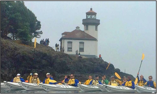 Kayakers near a lighthouse